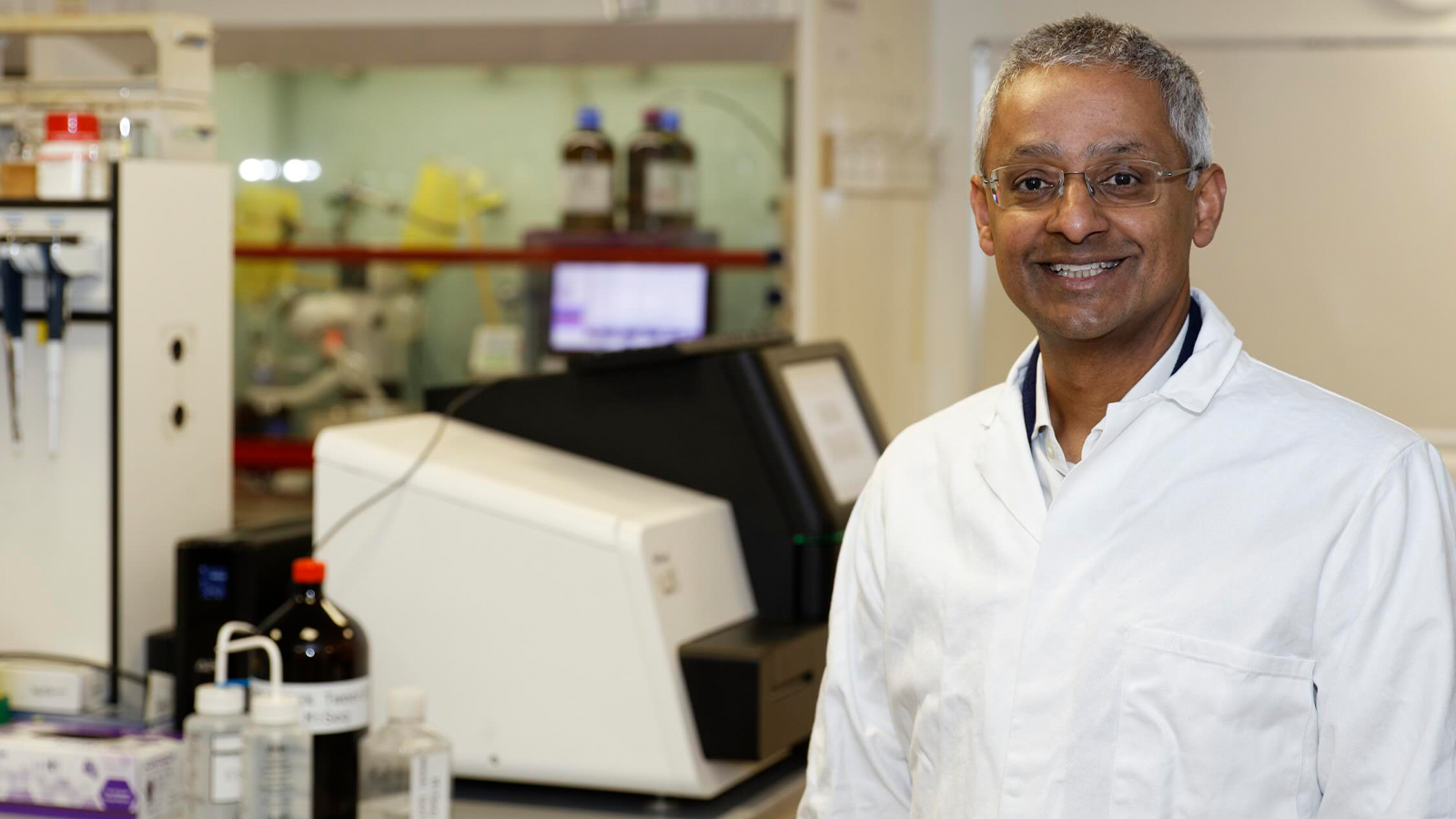 Professor Sir Shankar Balasubramanian in a lab coat
