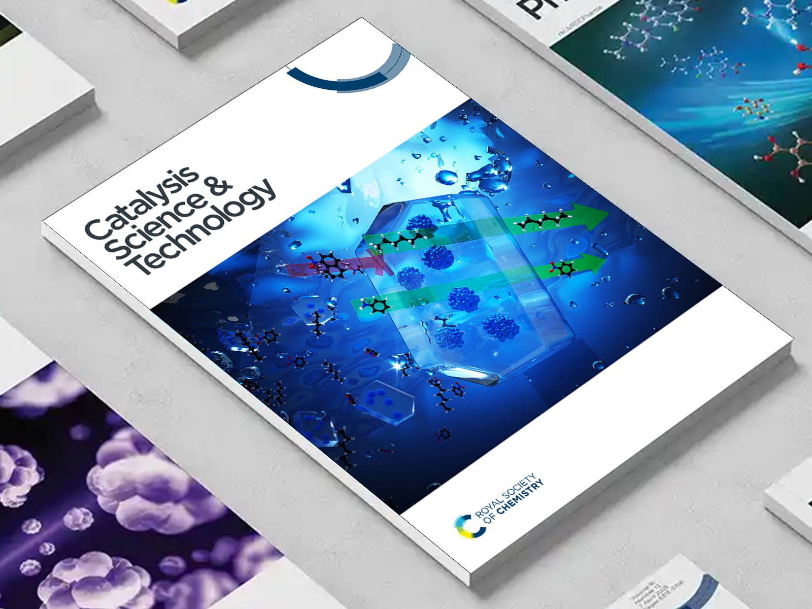 the Catalysis Science & Technology journal among a group of other journals on a desk