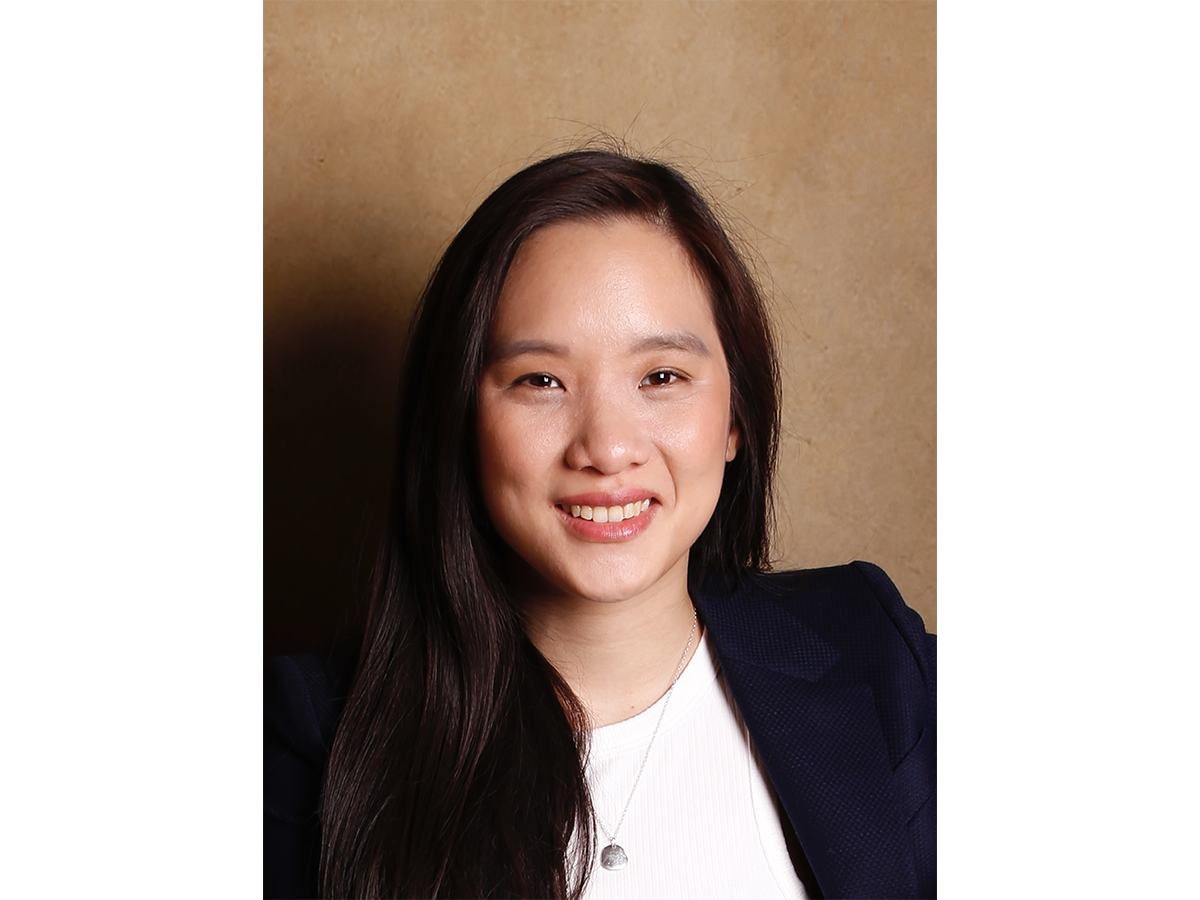 Dr Florence Huynh in a suit, smiling