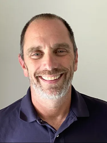 Steven Bensinger Steven Bensinger smiling wearing dark blue polo shirt