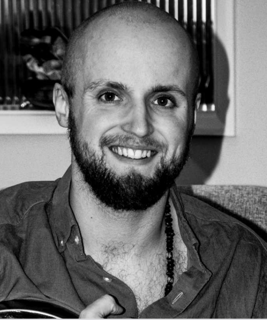 A black-and-white headshot of a smiling Dr James Pickering, of the University of Leicester