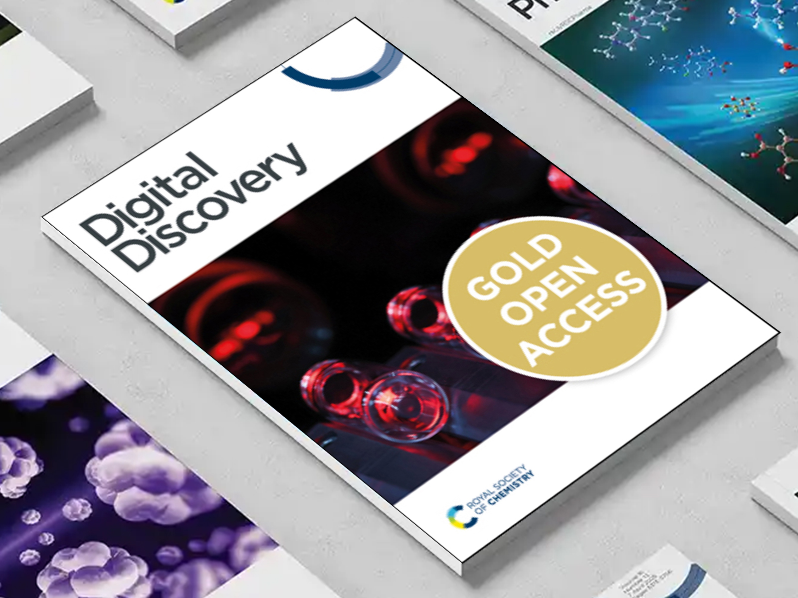 the Digital Discovery journal among a group of other journals on a desk