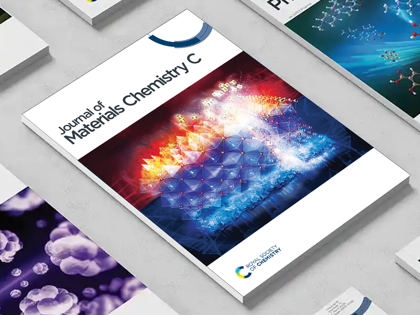 the JMC C journal among a group of other journals on a desk