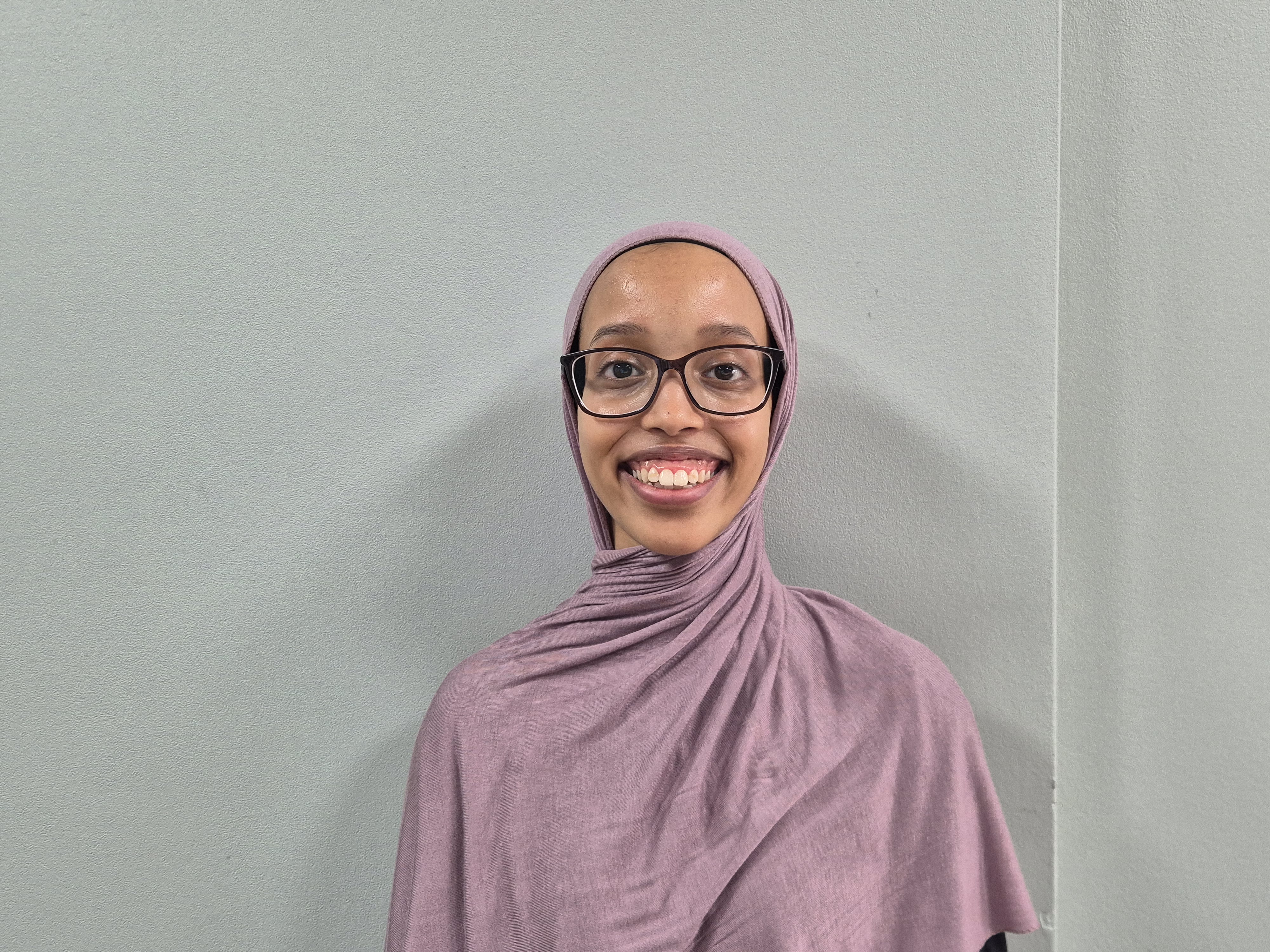 a woman wearing glasses and a scarf