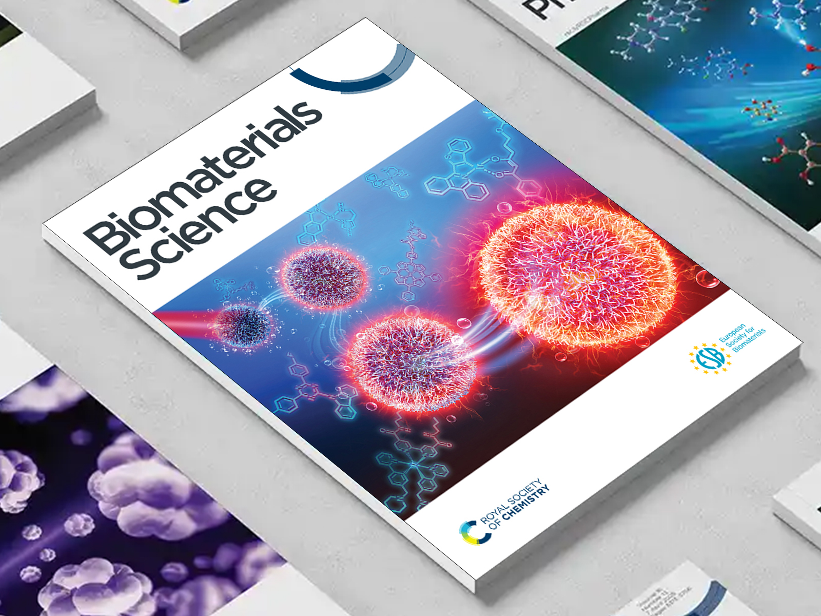 the Biomaterials Science journal among a group of other journals on a desk