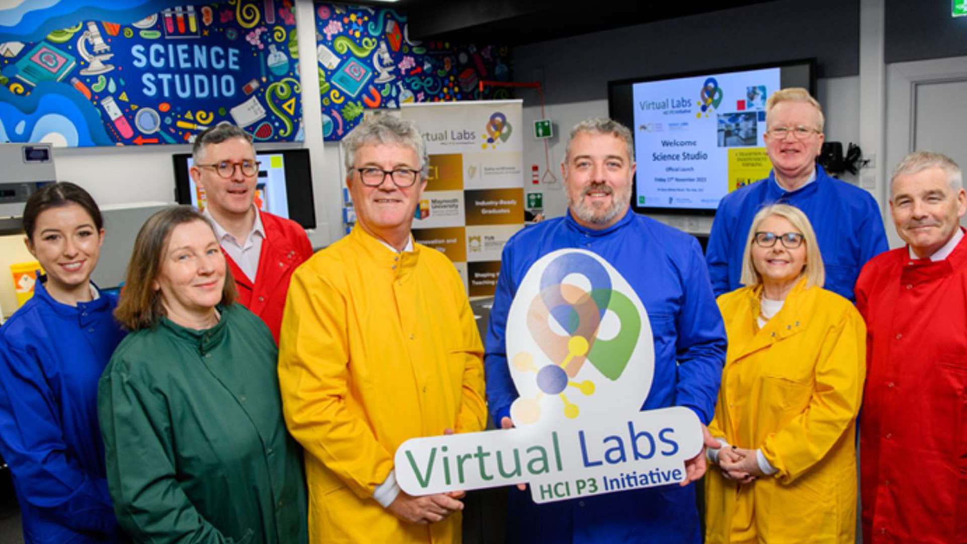 Virtual Labs Team in primary colour lab coats posing for camera