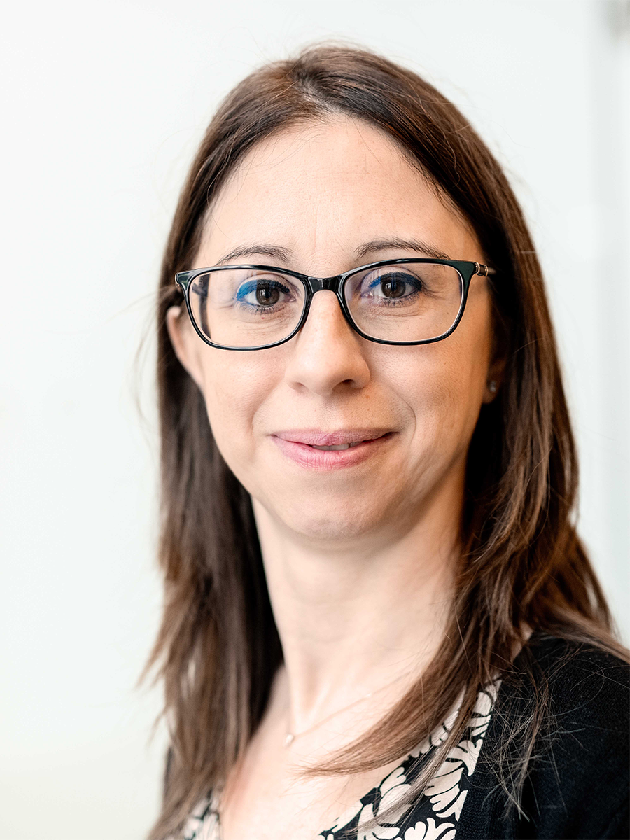 Francesca M. Toma smiling to camera wearing glasses