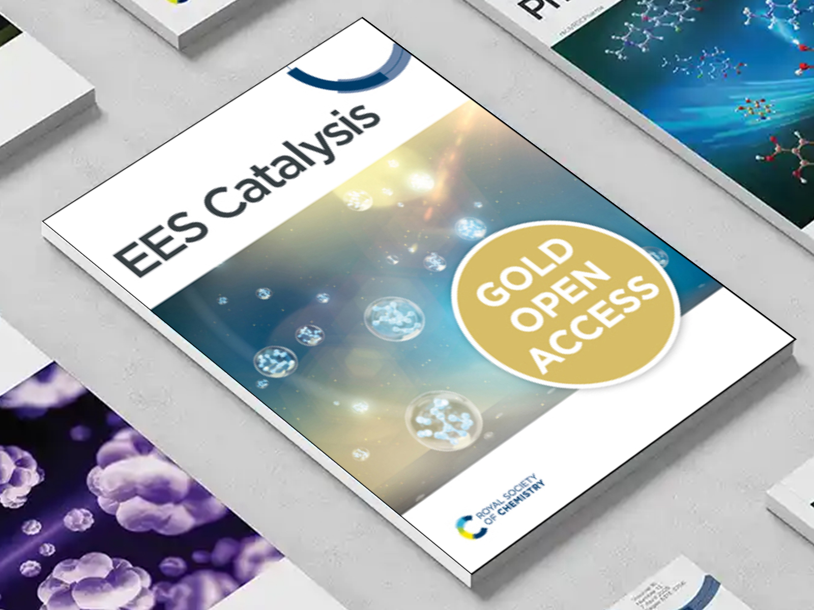the EES Catalysis journal among a group of other journals on a desk