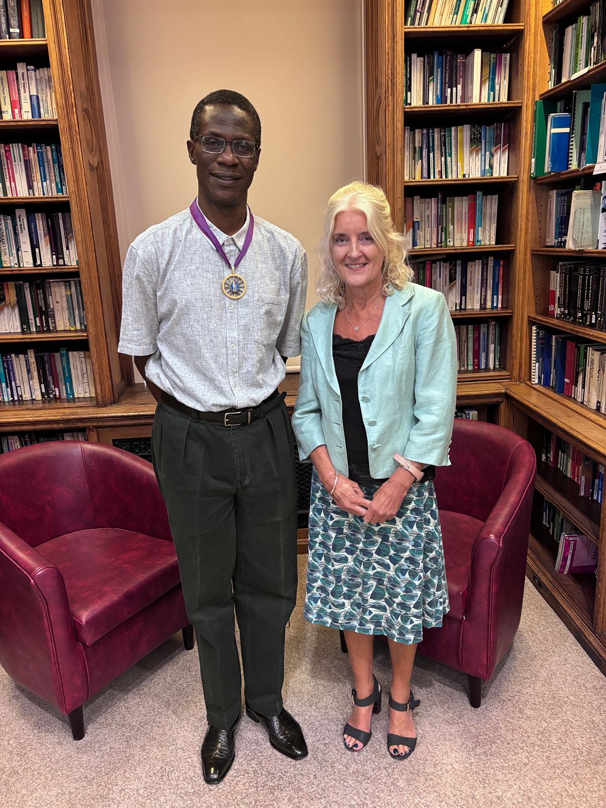 2026 AGM - Professor Robert Mokaya and Dr Annette Doherty 1200x1600 Professor Robert Mokaya and Dr Annette Doherty both smile to the camera in the Library Room surrounded by shelves of old books