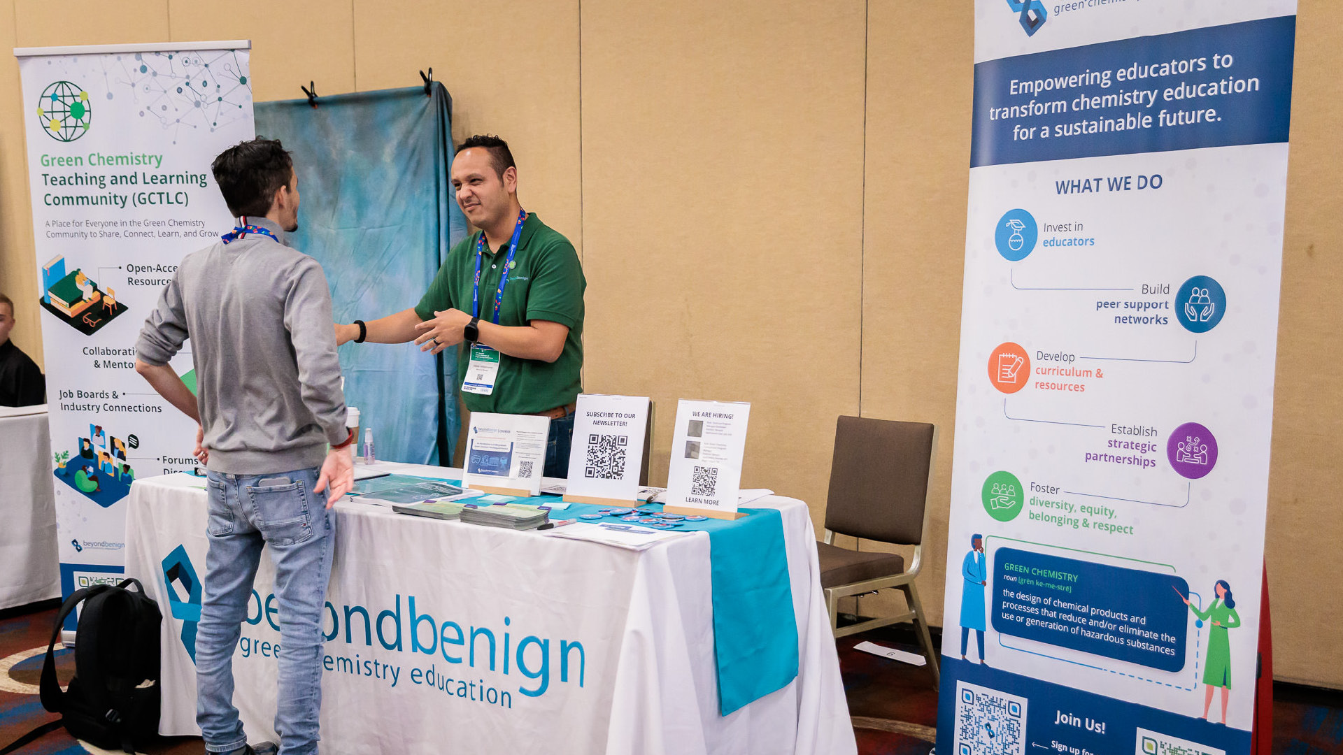 One of The Green Chemistry Commitment team explaining something at a stand