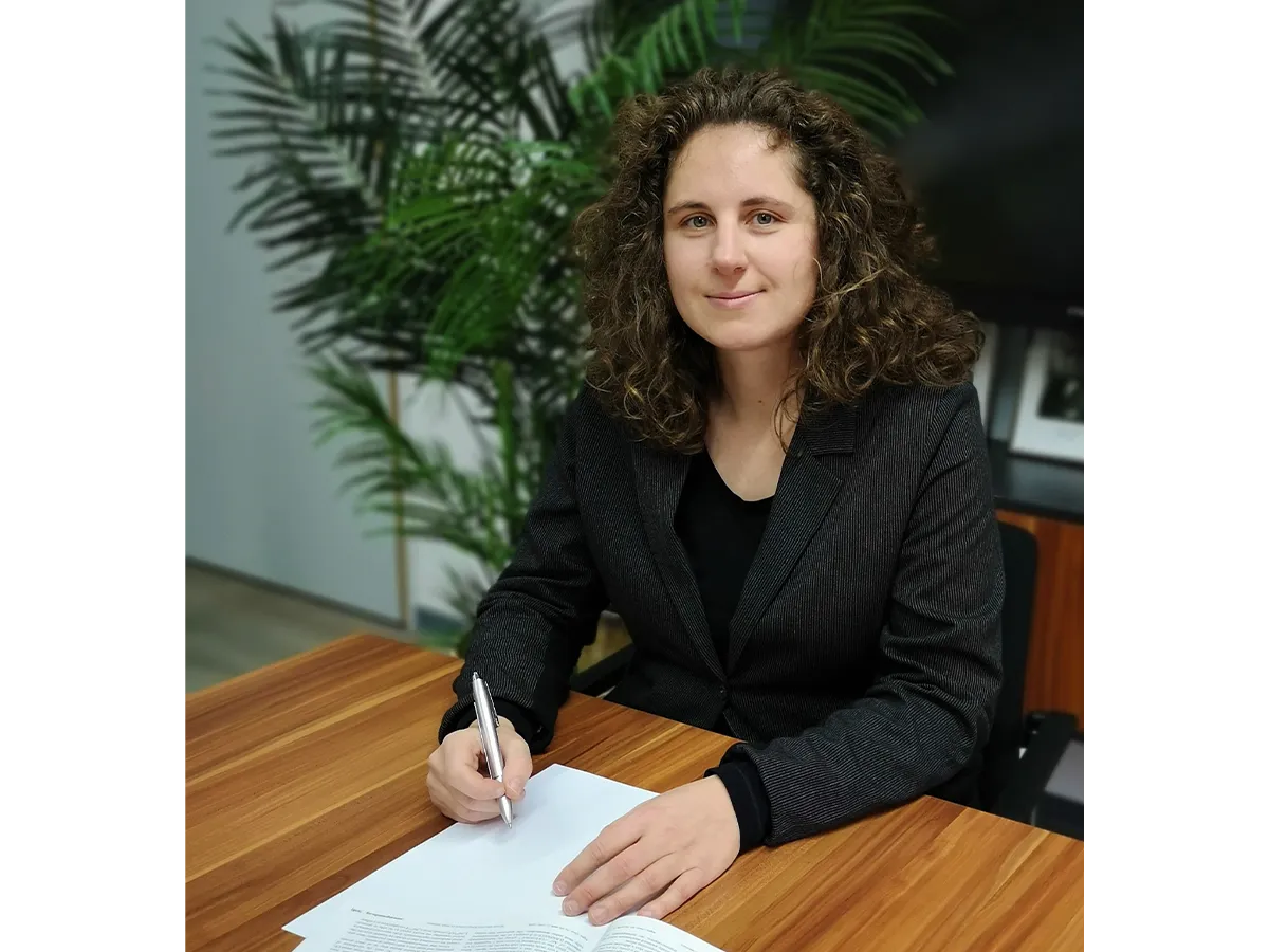 Franziska Schoenebeck at a desk writing on paper