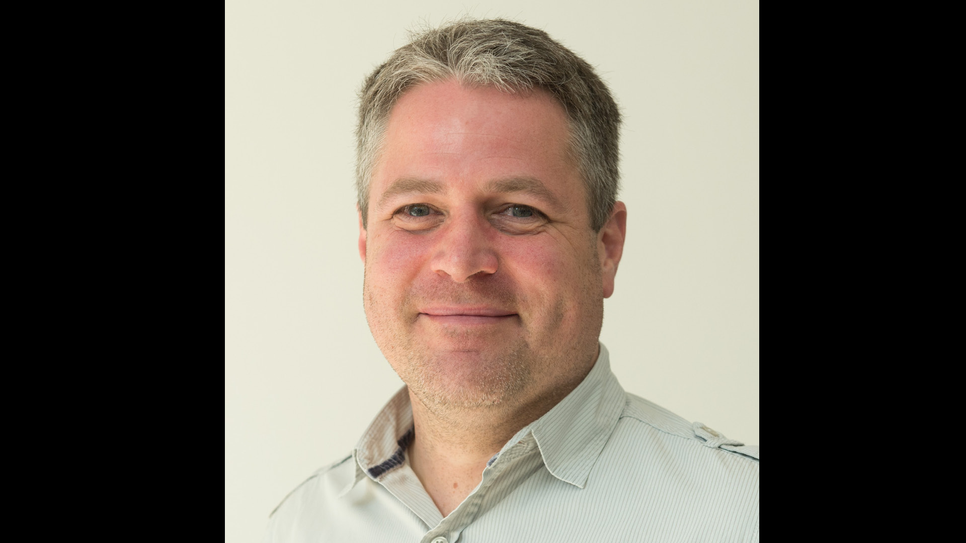 Paul Tyler Member of Did You Know team in shirt smiling to camera