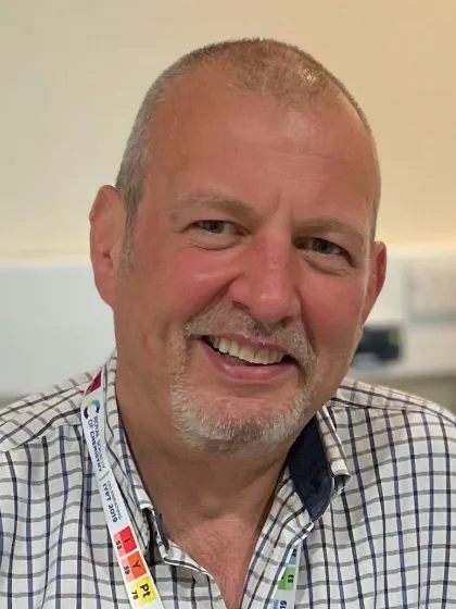 Professor Duncan Graham in check shirt, smiling at the camera