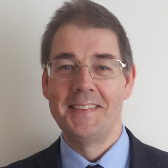 a man wearing glasses and a suit