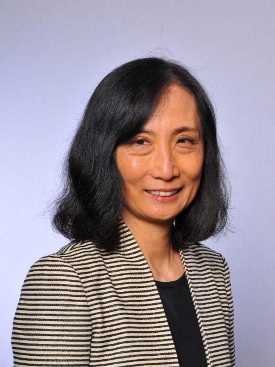 Lin Chen smiling to camera in striped top