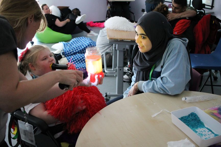 A young person enjoys a sensory experiment