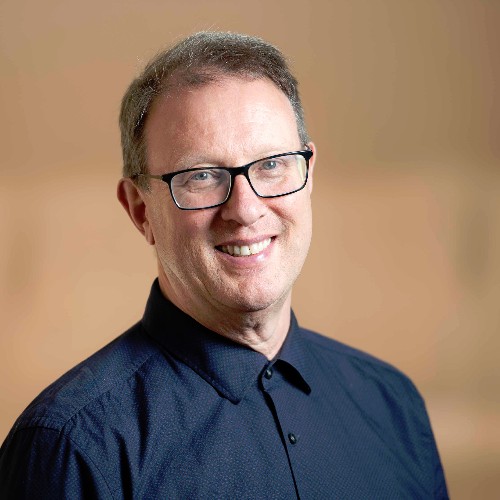 a man wearing glasses and a blue shirt