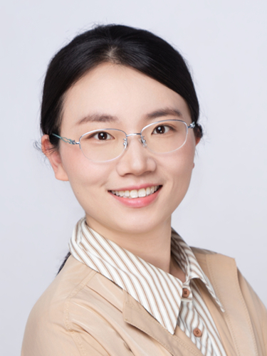 Quan Dylan Zhou smiling wearing striped shirt with blazer and glasses