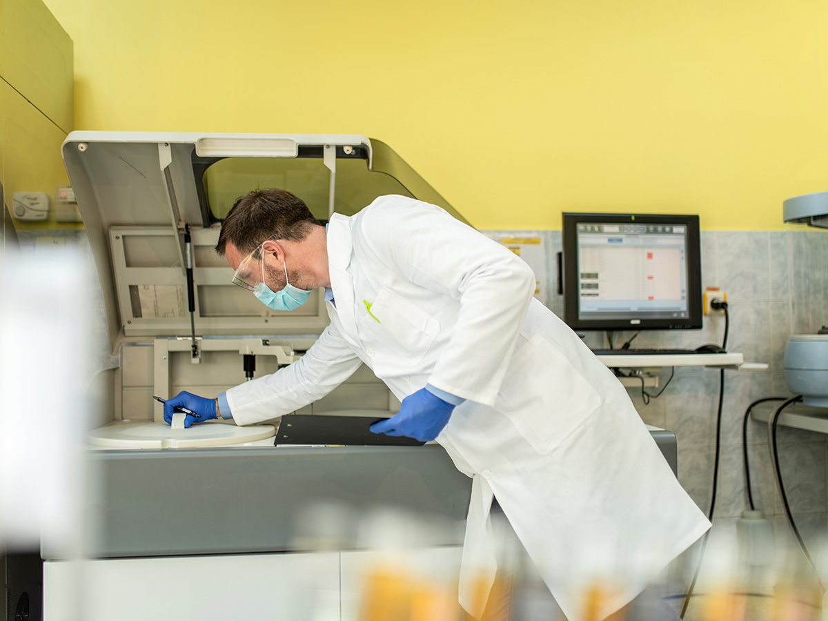 Adult Male Scientist Working at the Laboratory checking equipment