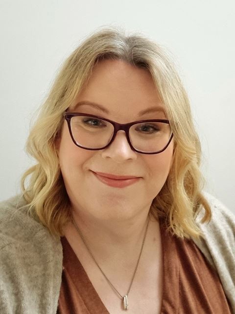 Tanja Junkers smiling to camera, wearing glasses