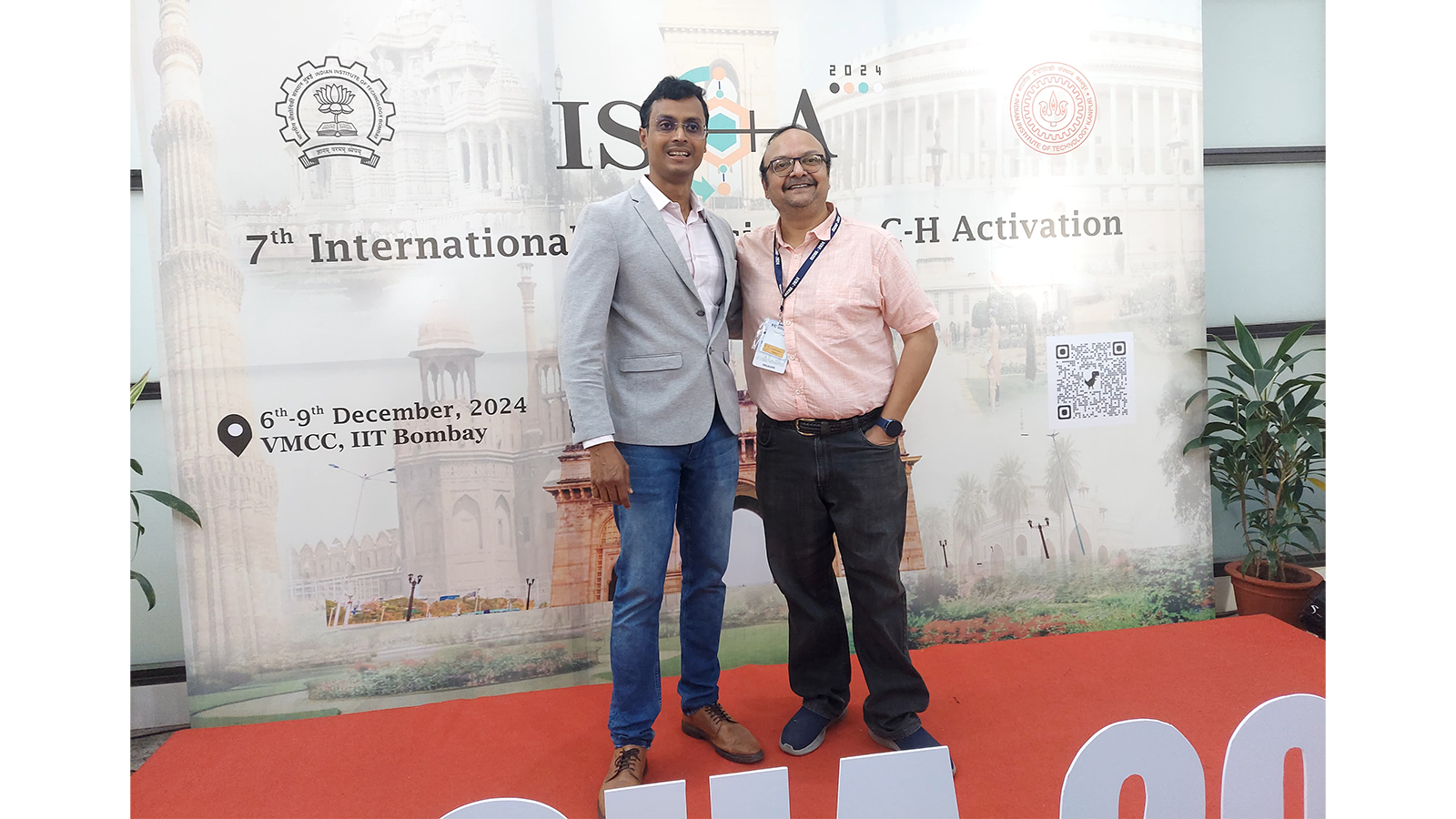 Two of AEEon Collective team posing for photos at an event