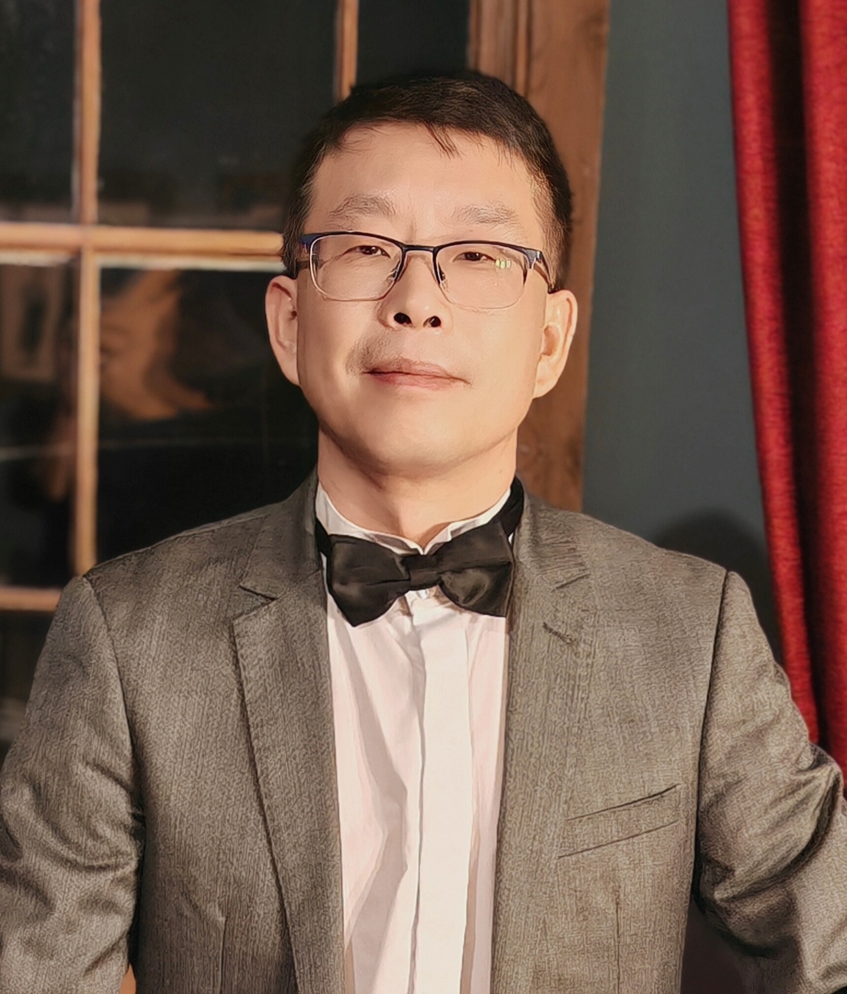 a man in a suit and bow tie