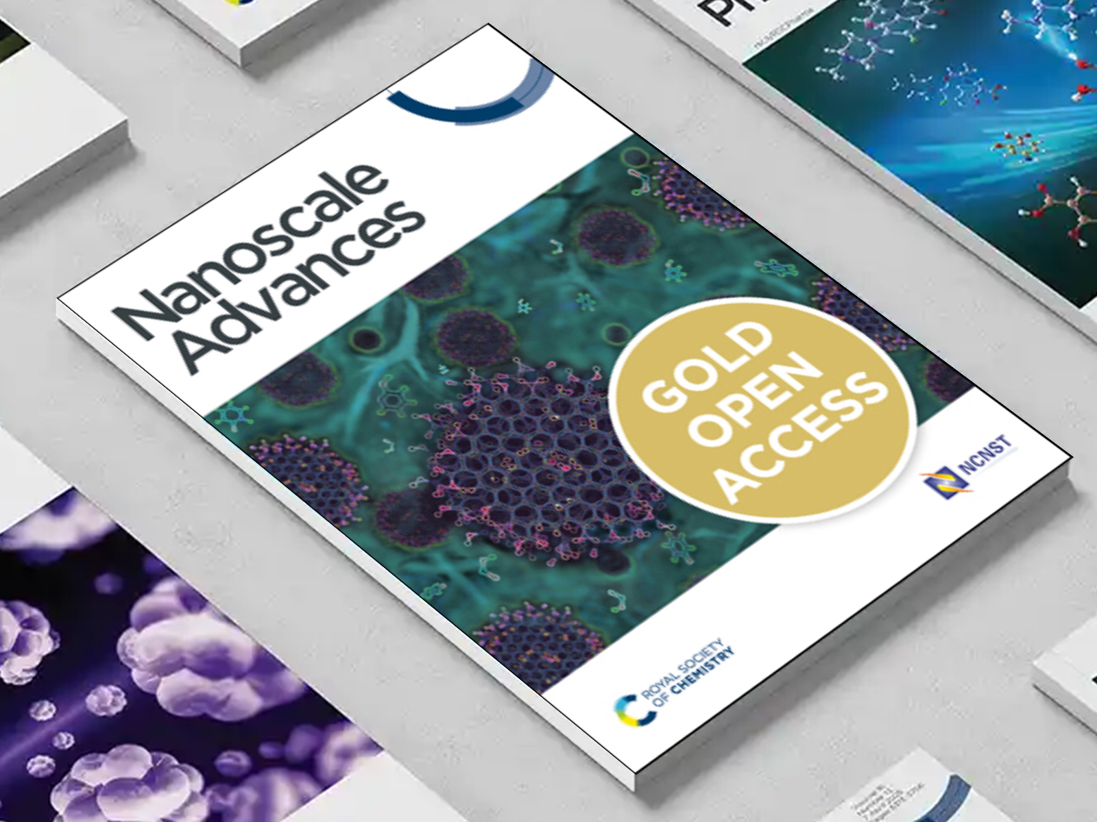 the Nanoscale Advances journal among a group of other journals on a desk