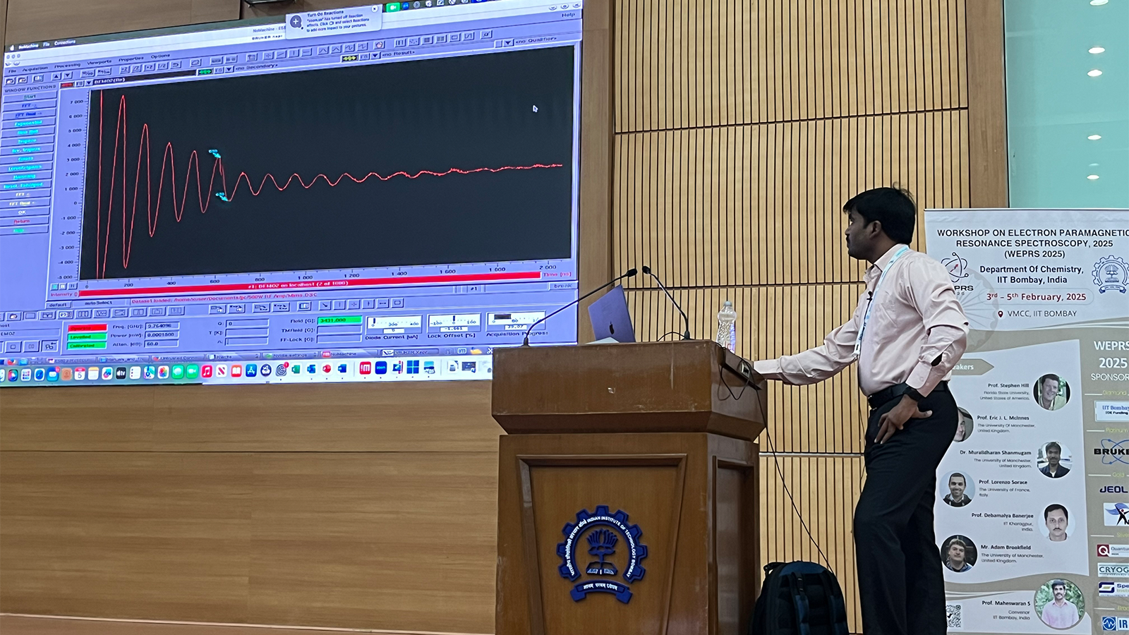 Dr Muralidharan Shanmugam, Senior Technical Specialist, EPSRC NRF for EPR, University of Manchester, presenting findings on podium