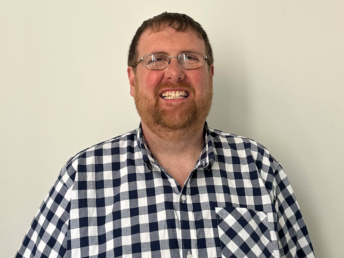 Professor Damion Corrigan in glasses and check shirt