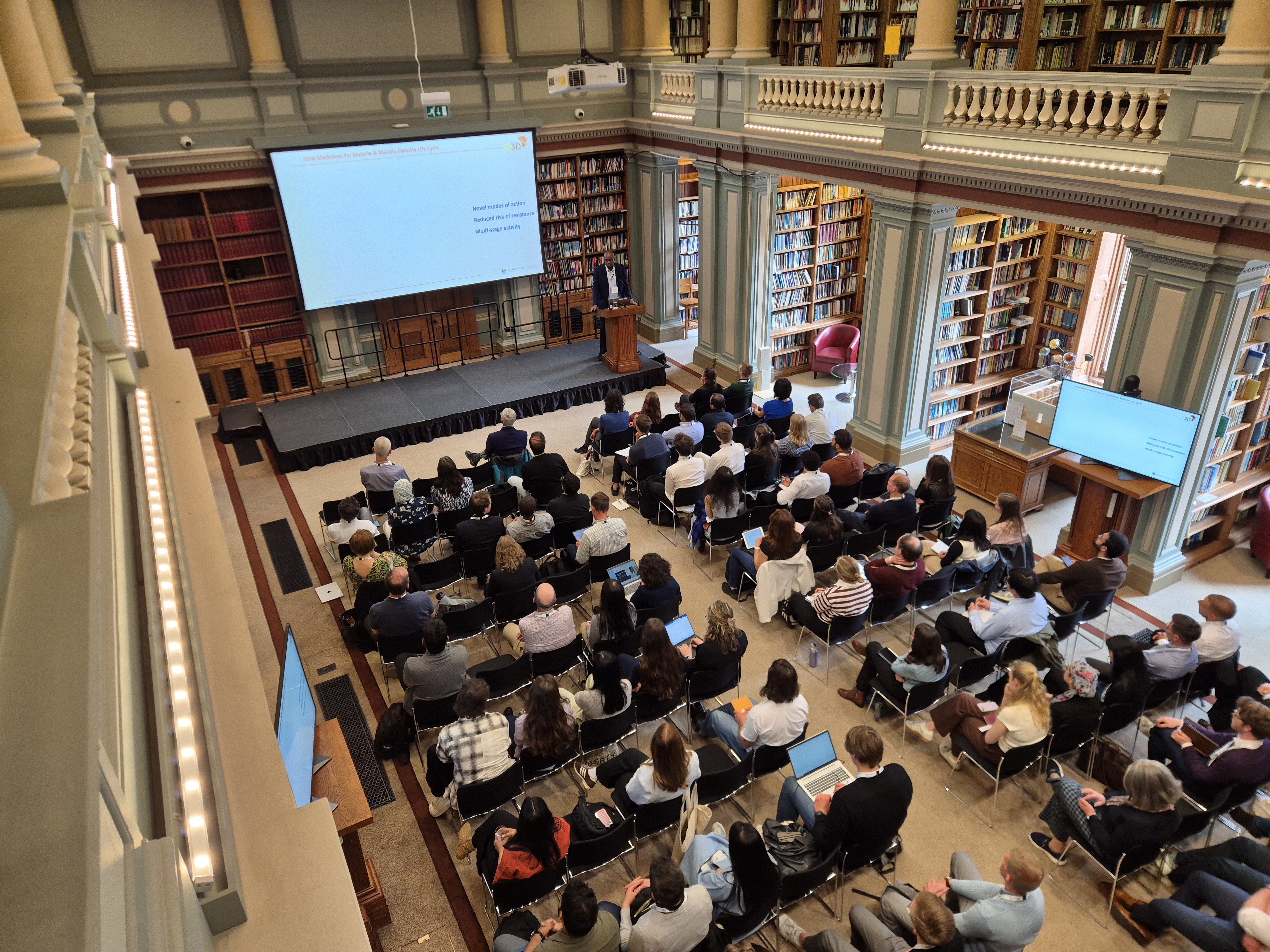 Rows of people watch a presentation in the library