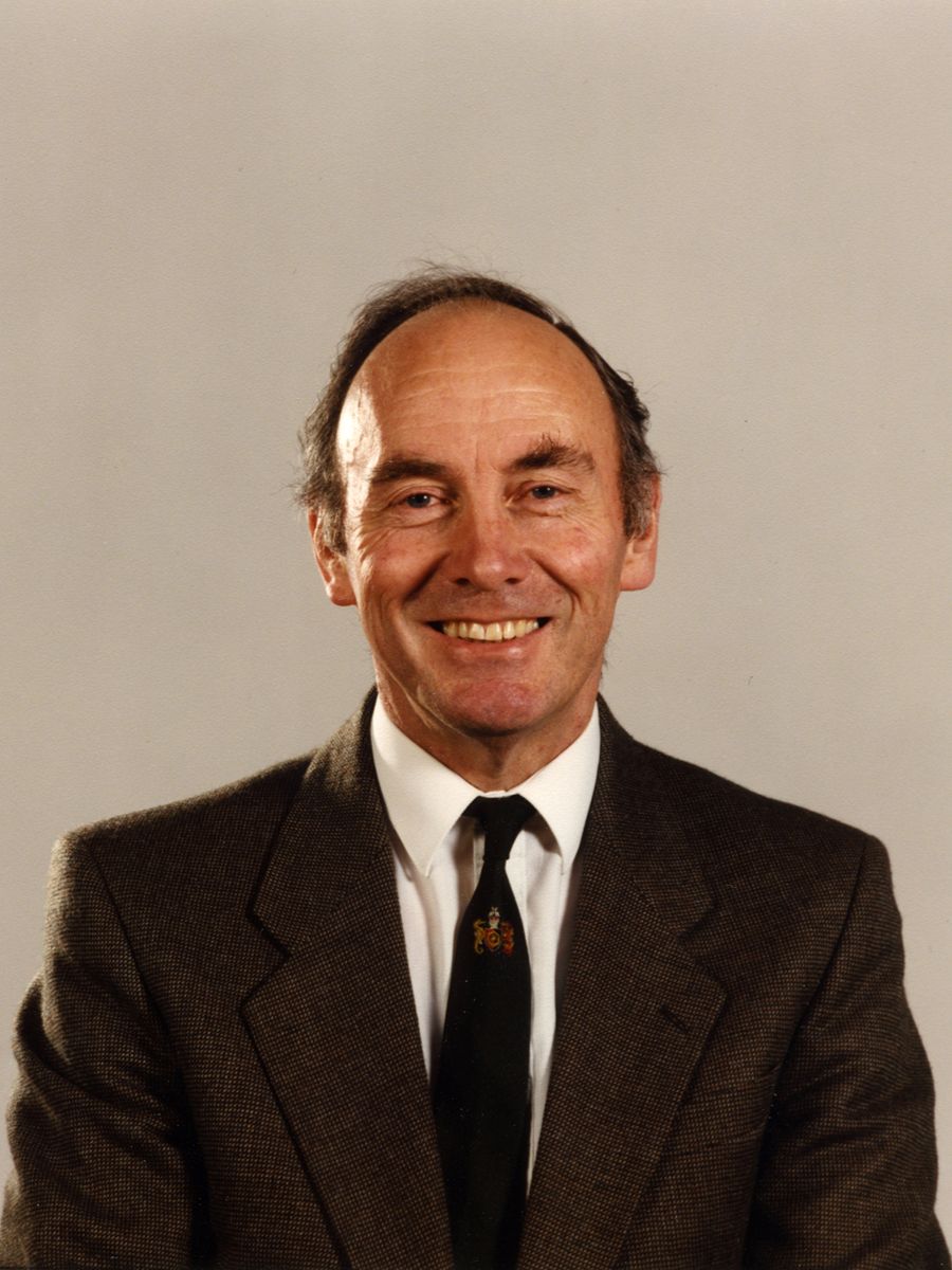 John Pentland smiling to camera in suit, shirt and tie