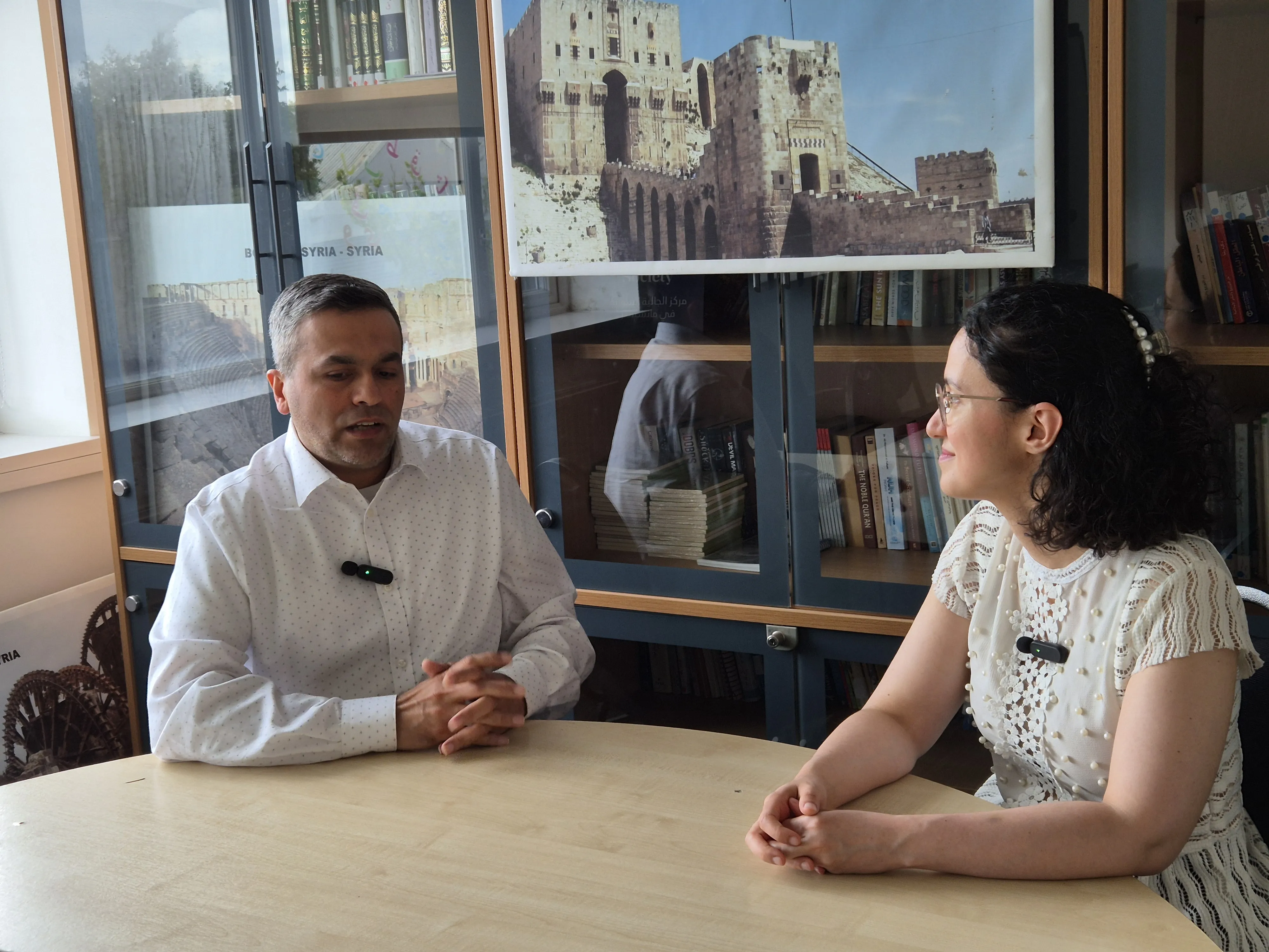 Abdullatif Alfutimie and Alaa Zam Abdullatif Alfutimie left Alaa Zam talking at a desk in a room at Burlington House