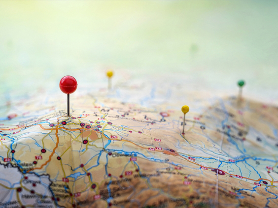 Pins on a map with raised areas for mountains