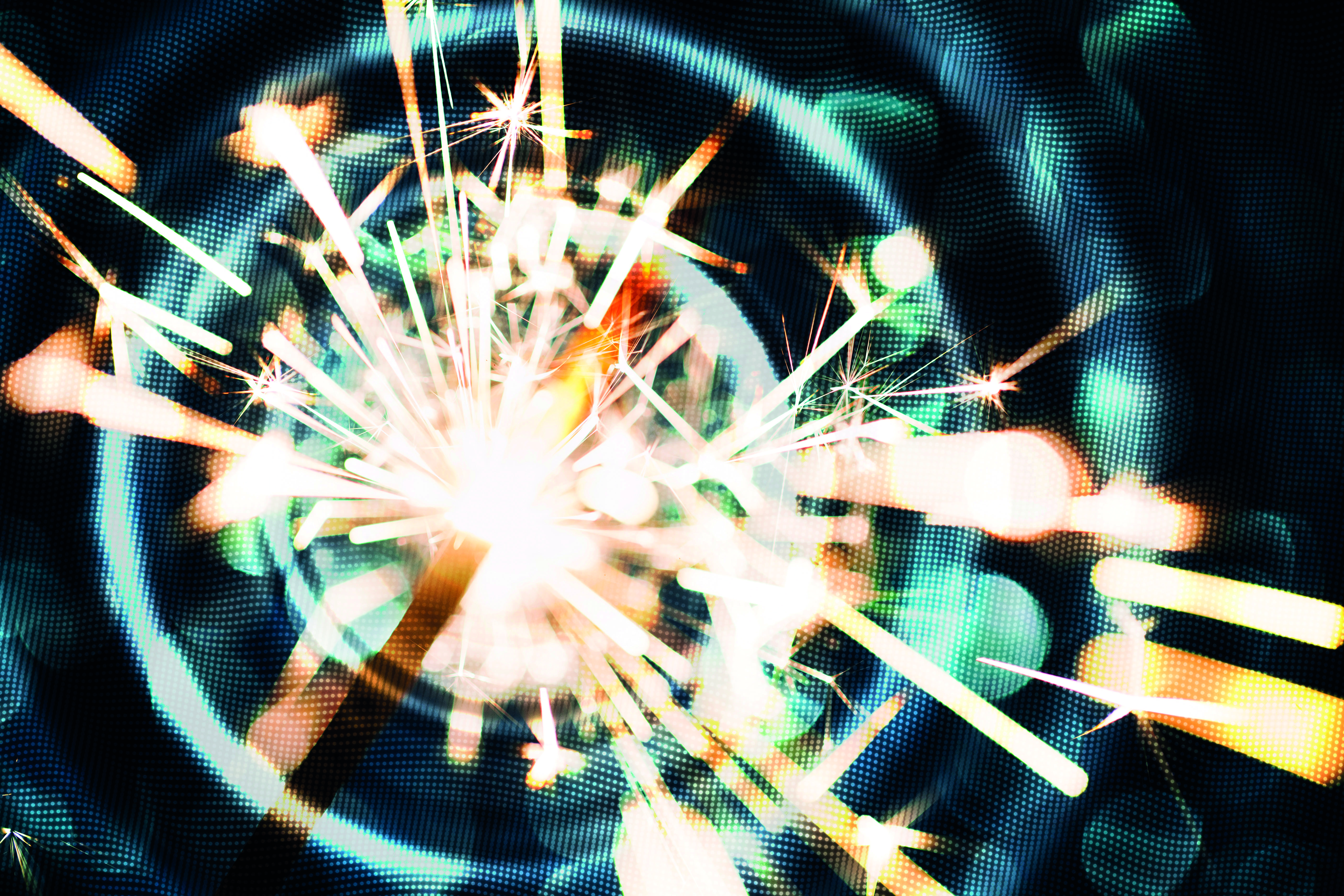 Sparkler on defocused blue background photo