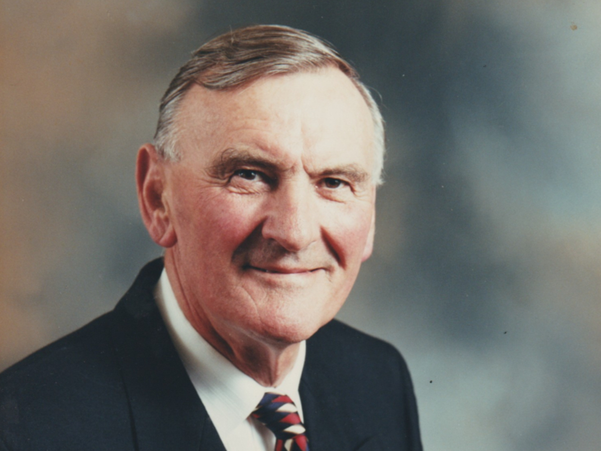 Headshot of John W Lewis smiling to camera in suit jacket and tie