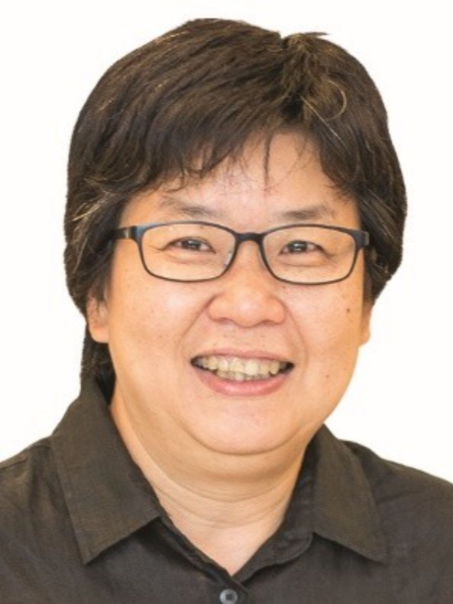 Christina smiling to camera wearing glasses