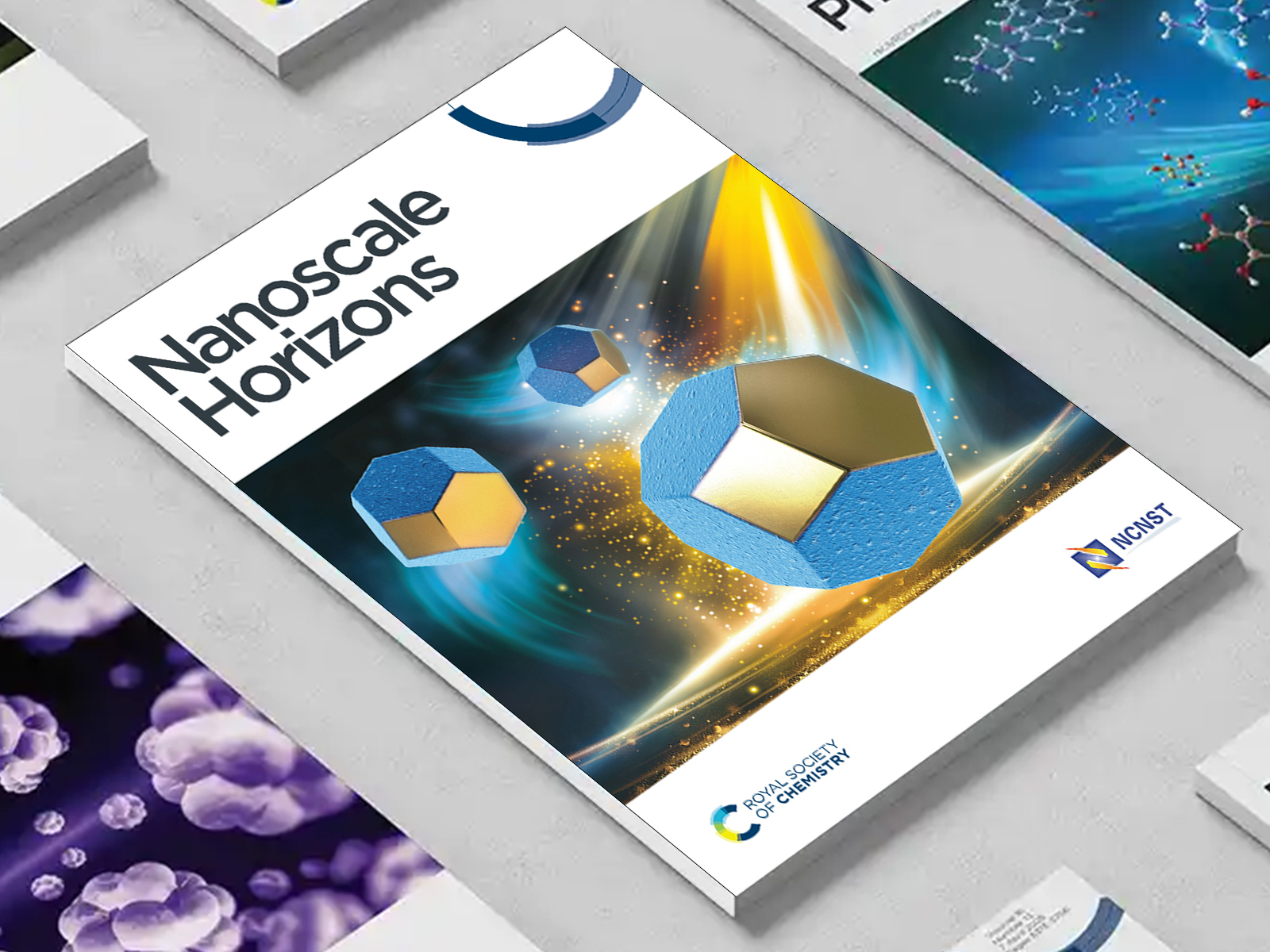 the Nanoscale Horizons journal among a group of other journals on a desk