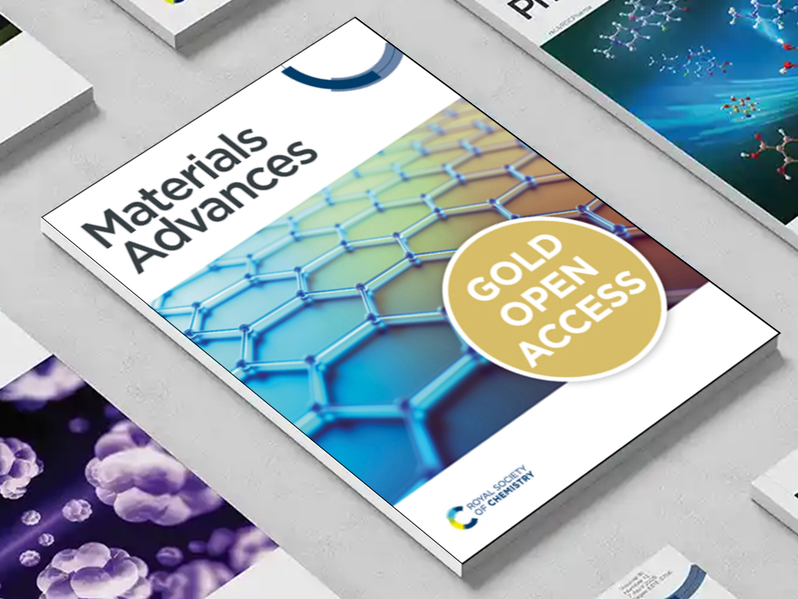 the Materials Advances journal among a group of other journals on a desk