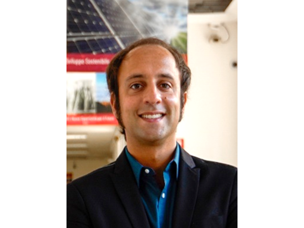Federico Bella smiling to camera in blue shirt and suit jacket