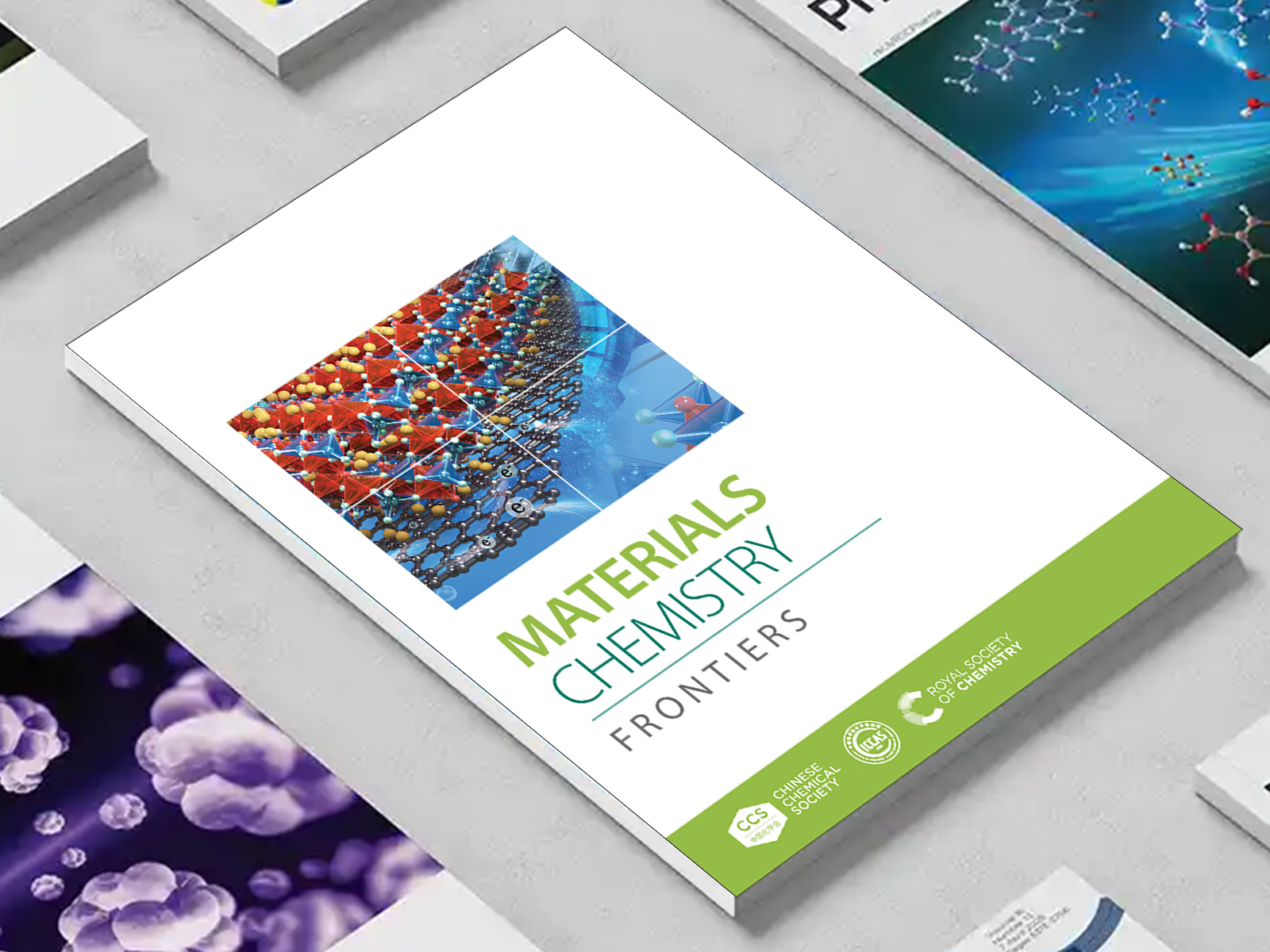 the Materials Chemistry Frontiers journal among a group of other journals on a desk