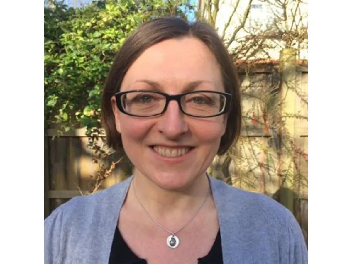 Dr Jennifer Kingston wearing glasses and smiling for the camera