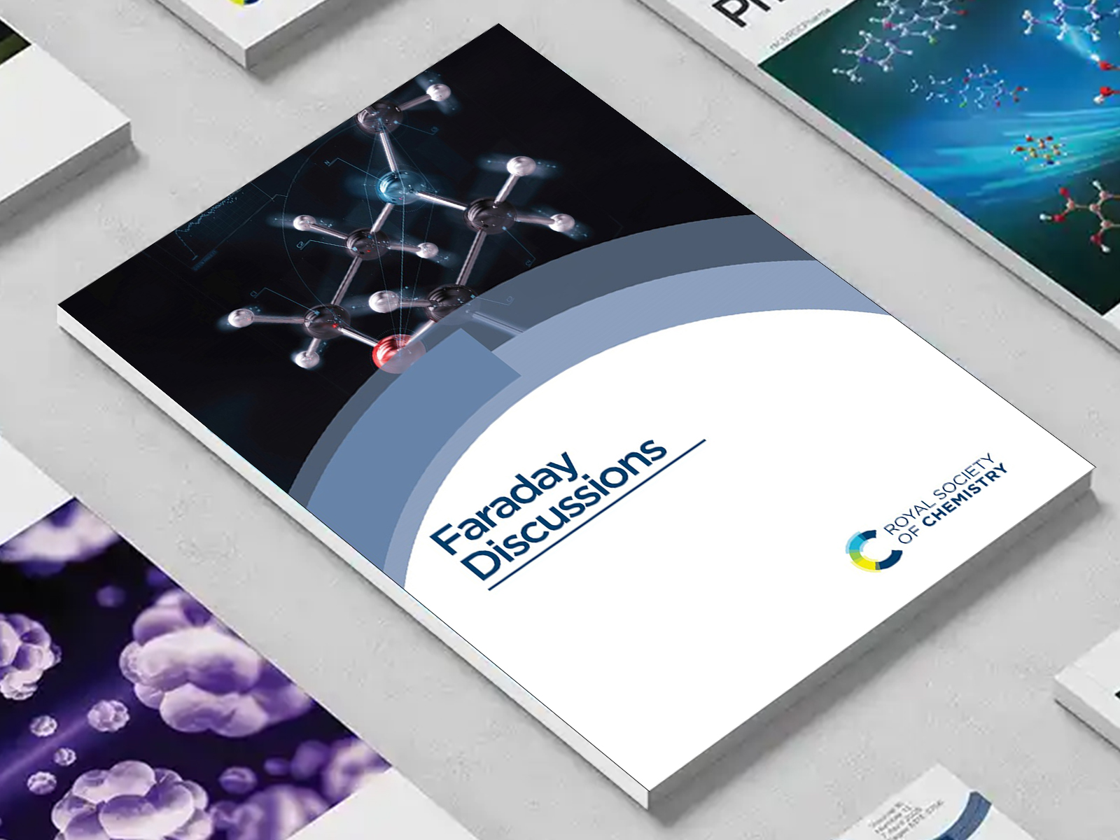 the Faraday Discussions journal among a group of other journals on a desk