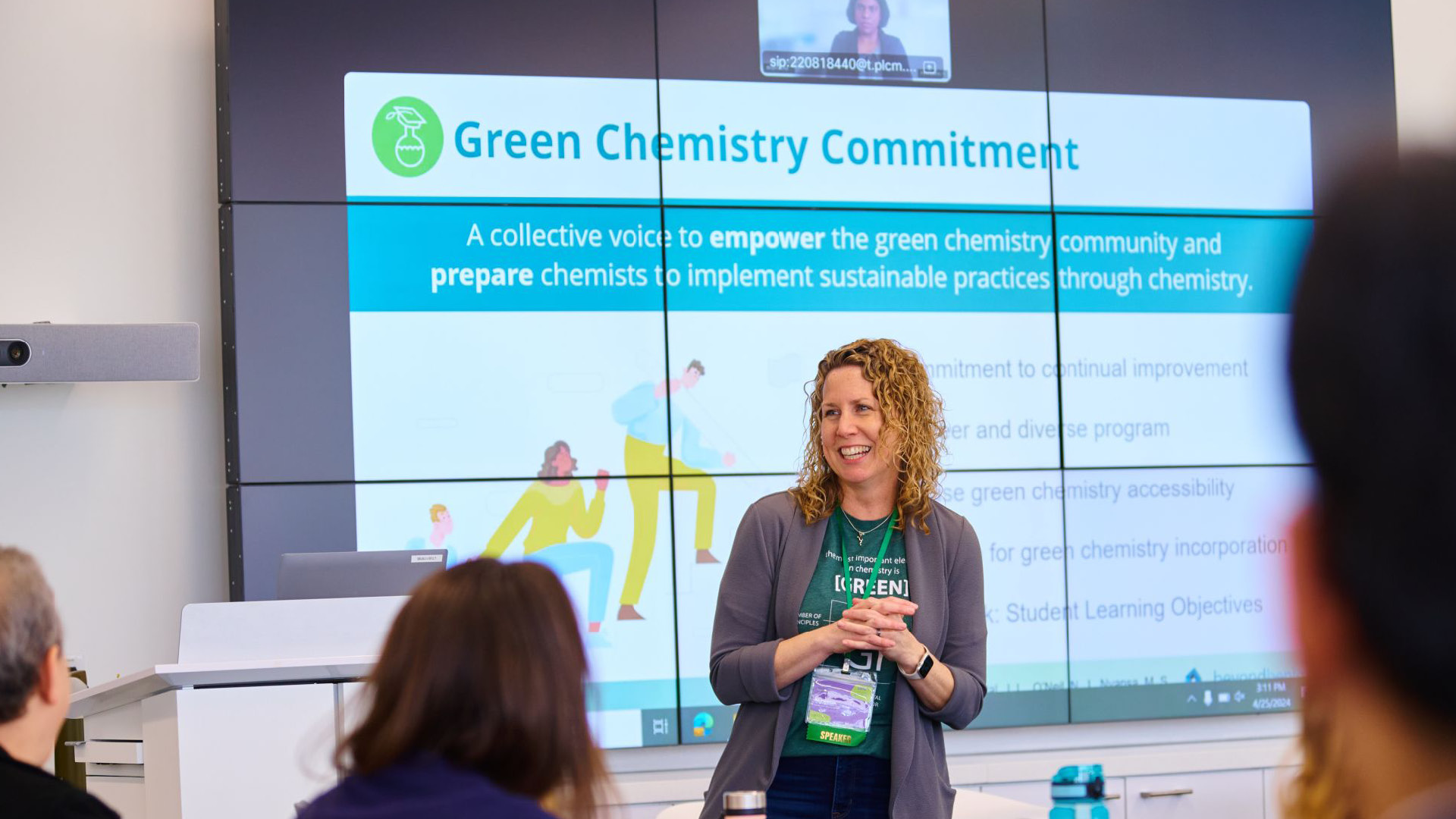 The Green Chemistry Commitment team member lecturing in front of large screen