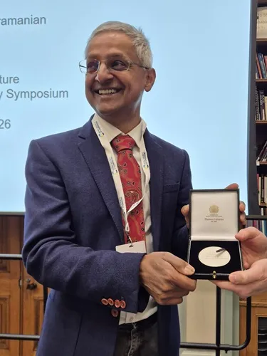 Professor Sir Shankar Subramanian with his 2025 RSC Khorana Prize Professor Sir Shankar Subramanian smiles as he looks off camera while holding his 2025 RSC Khorana Prize