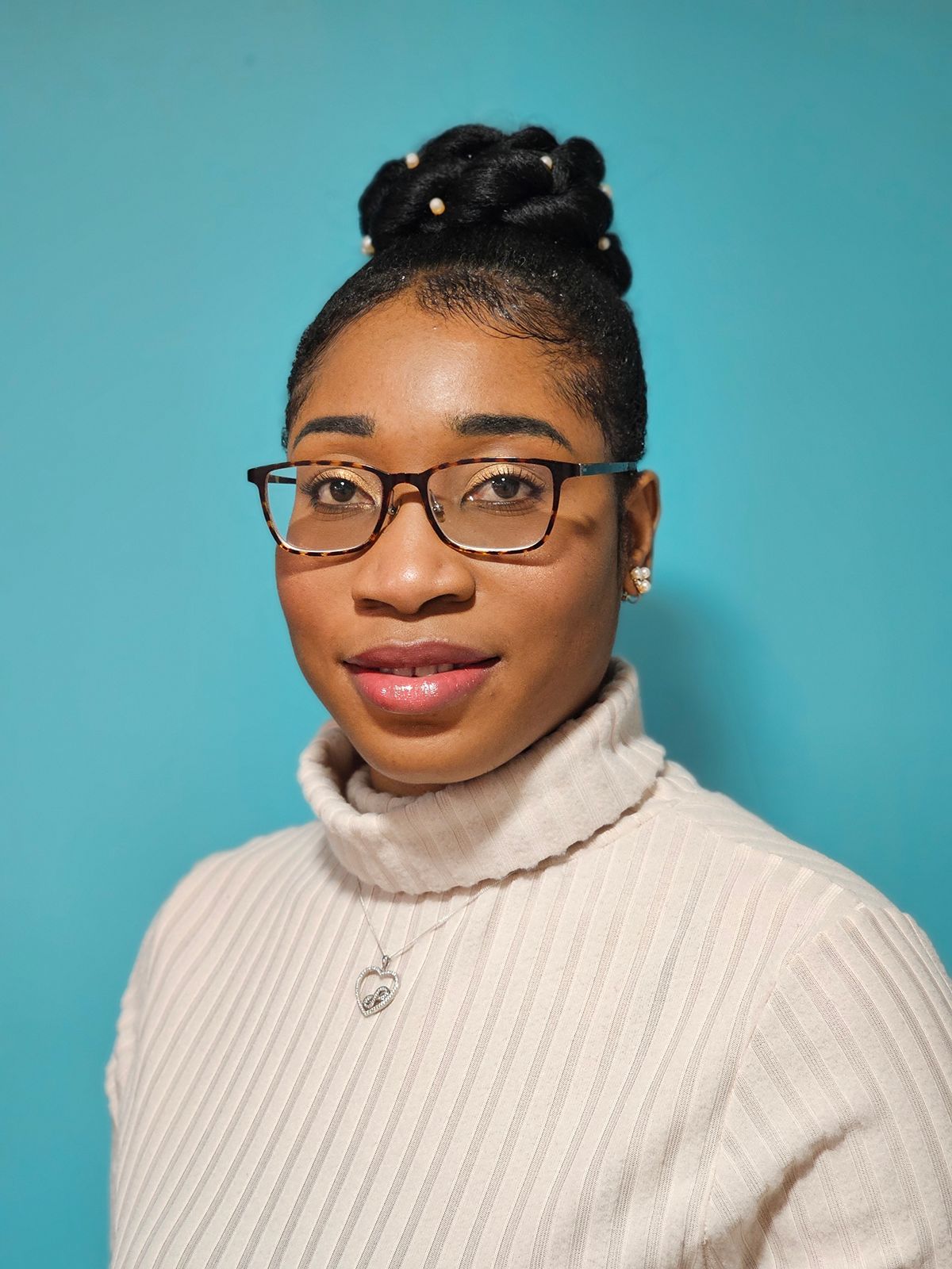 Dr Grace Tabi A headshot of Dr Grace Tabi, who is wearing glasses and a white turtleneck