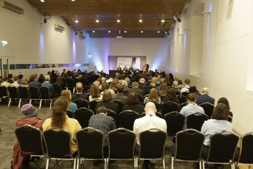 Scores of delegates sit in Our Dynamic Earth and watch one of the discussions