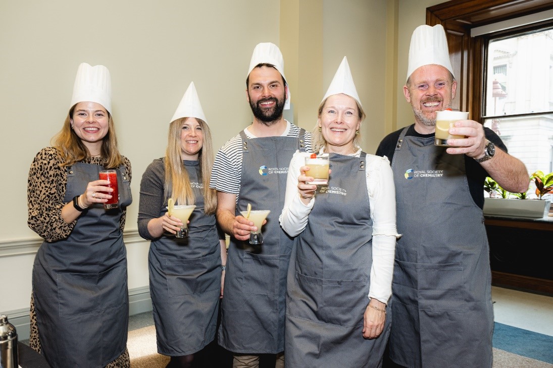 Group of people posing with cocktails