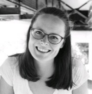 a woman wearing glasses smiling