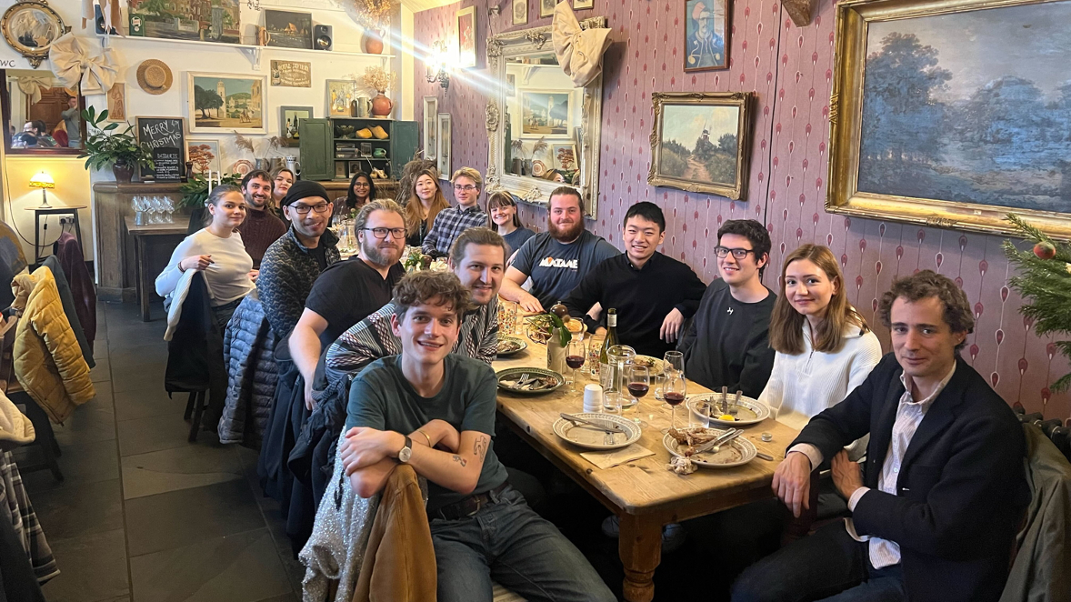 Dr Pietro Sormanni with a group of people sitting around a long dinner table
