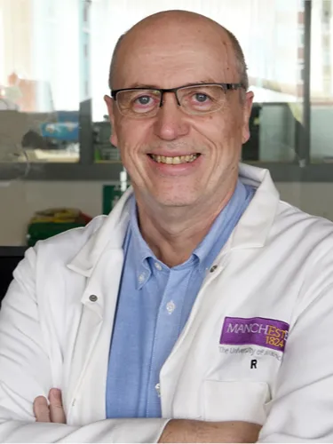 David Leigh photo 3 by 4 Professor David Leigh smiling wearing a white lab coat and glasses